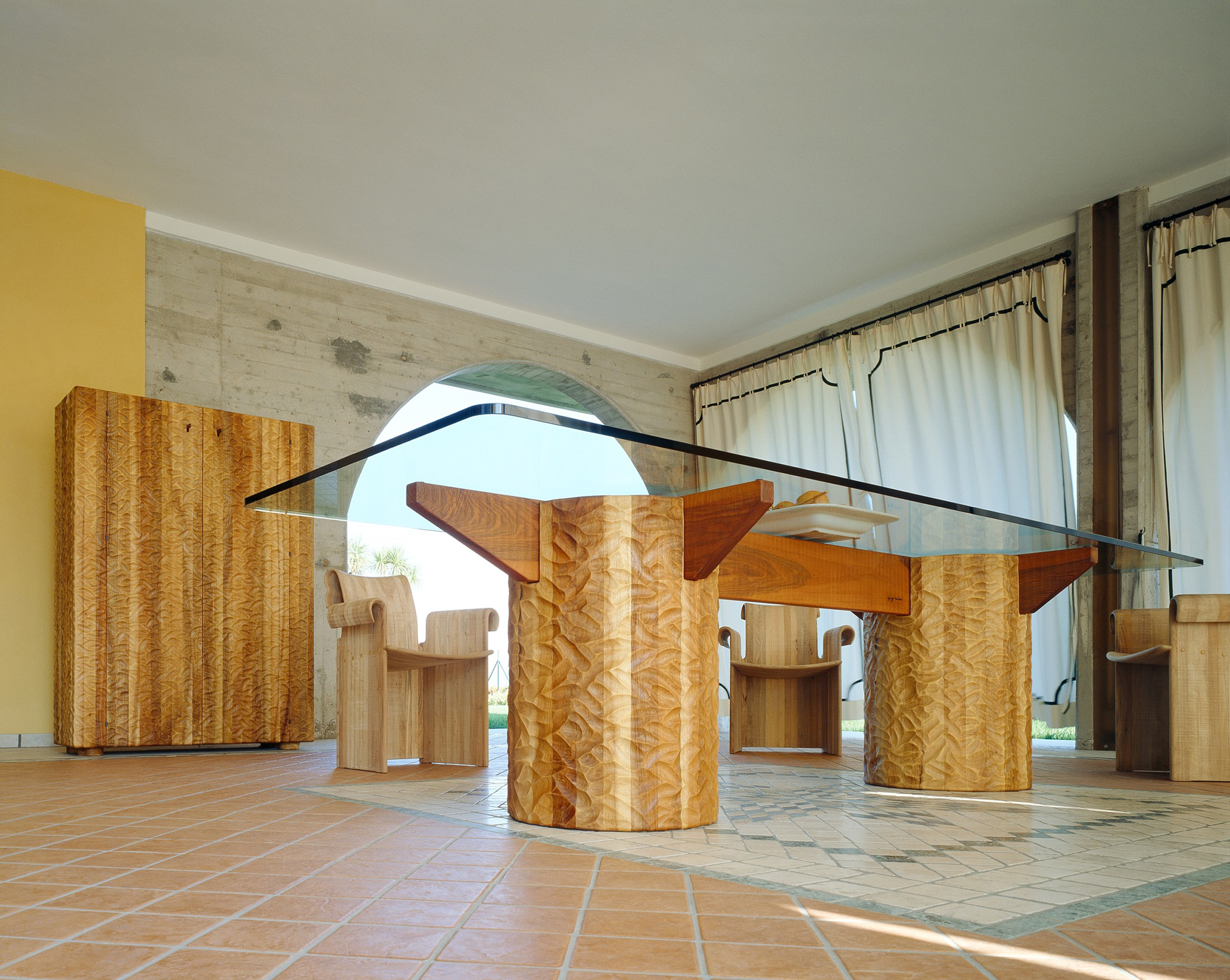 Table in Italian walnut with bespoke glass top, with hand-gouged finish