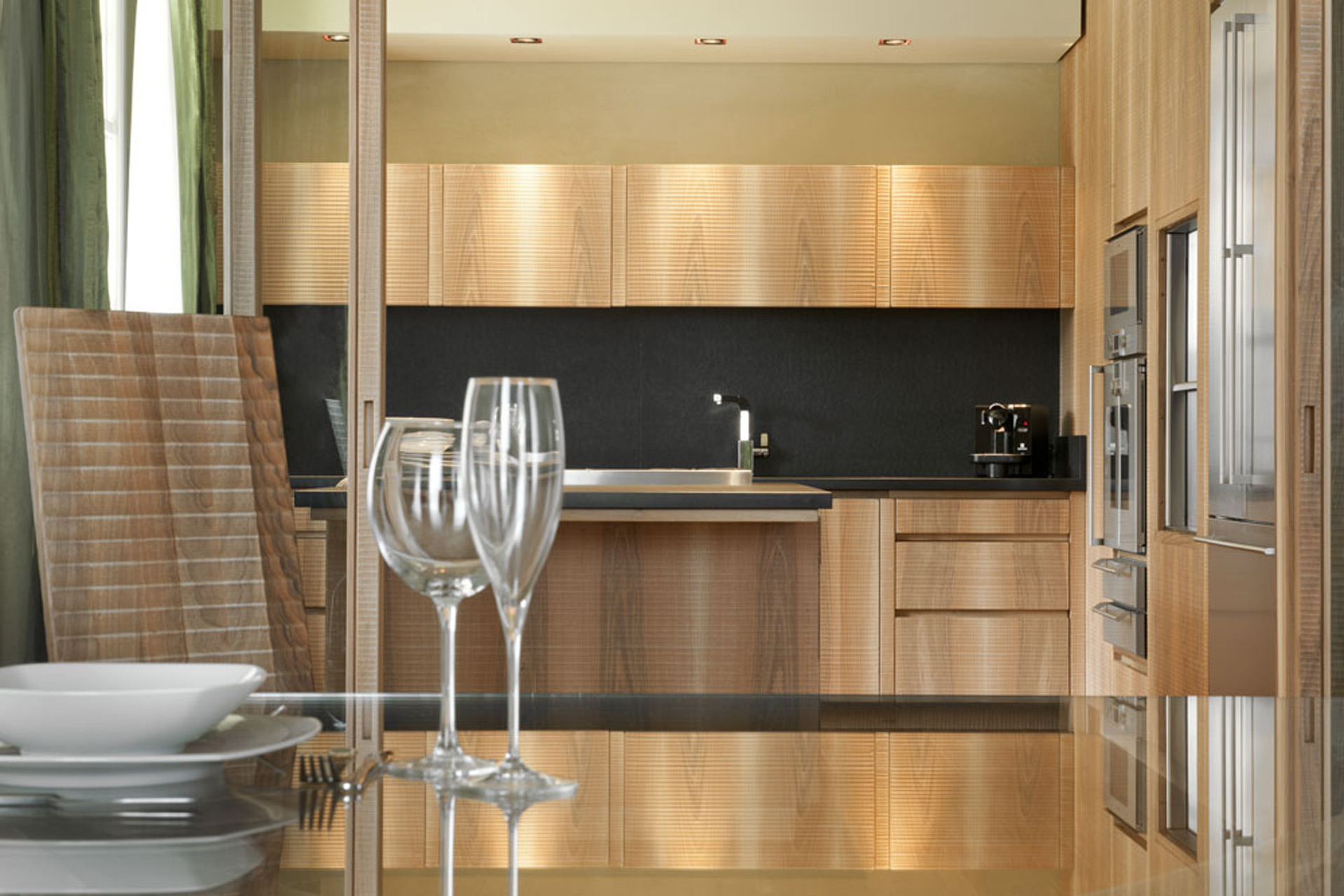 Kitchen in Italian walnut with sheer black granite surface.