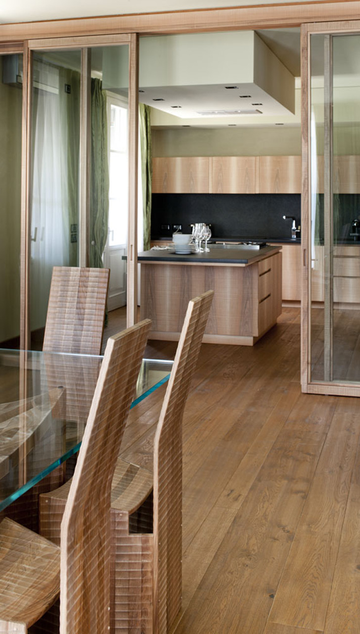 Kitchen in Italian walnut with sheer black granite surface.