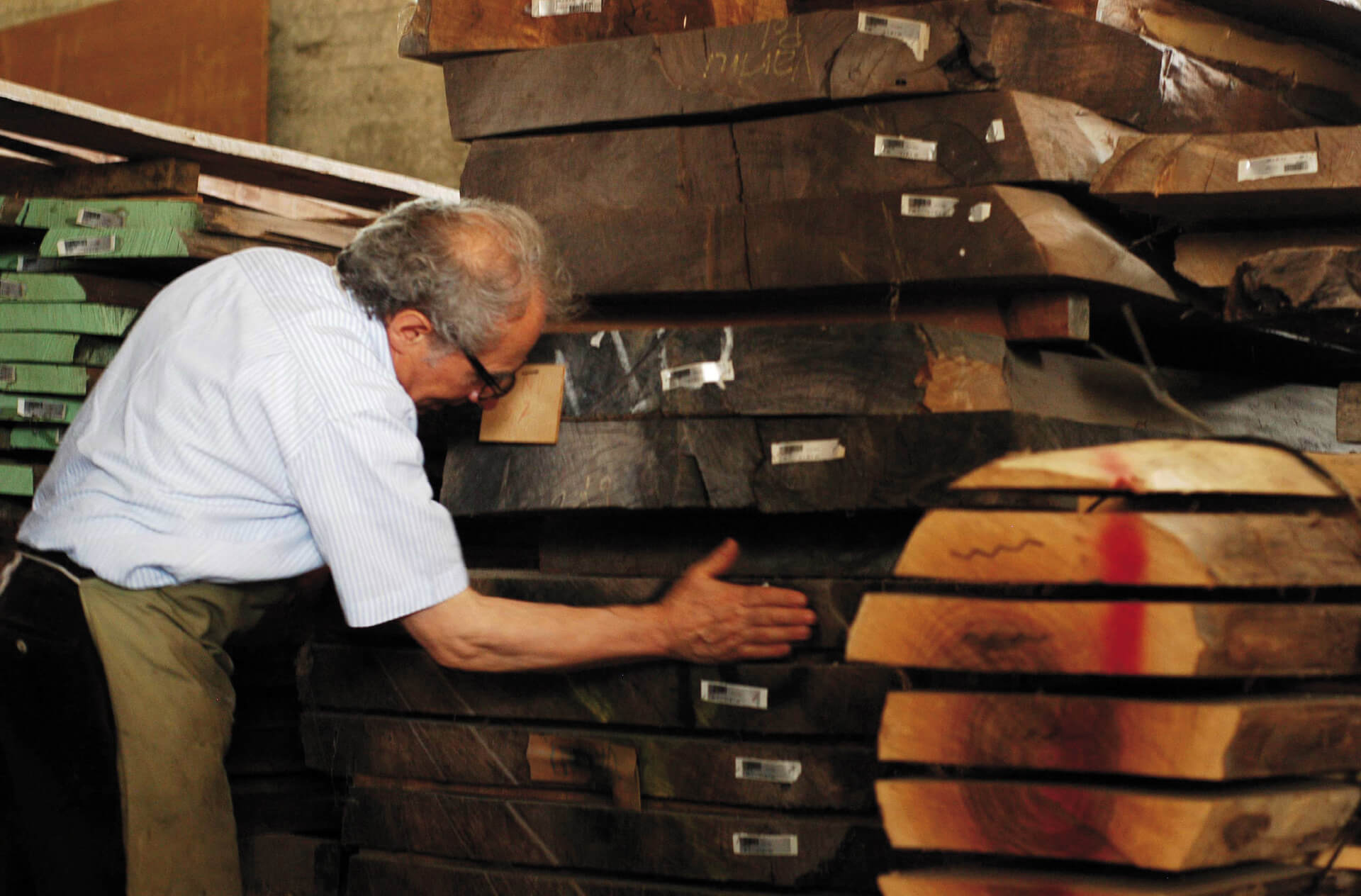 The artist Giuseppe Rivadossi among the wood boards in his atelier